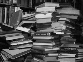 Stacks of dusty books black and white