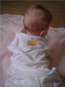 Baby in Noah's Inspirations onesie. Back logo. All rights reserved.
